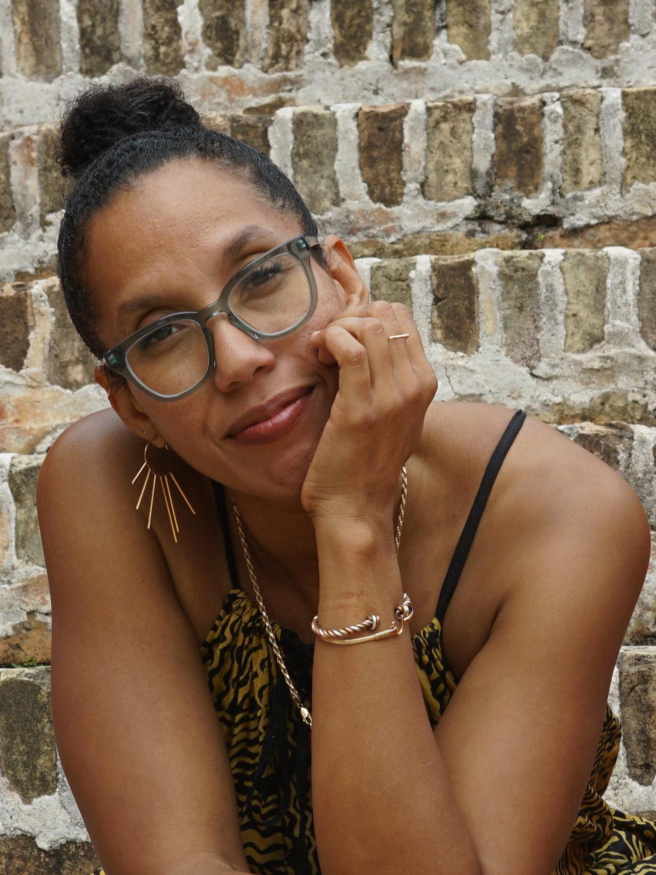 Headshot of Professor Tiphanie Yanique smiling in front of a brown brick wall